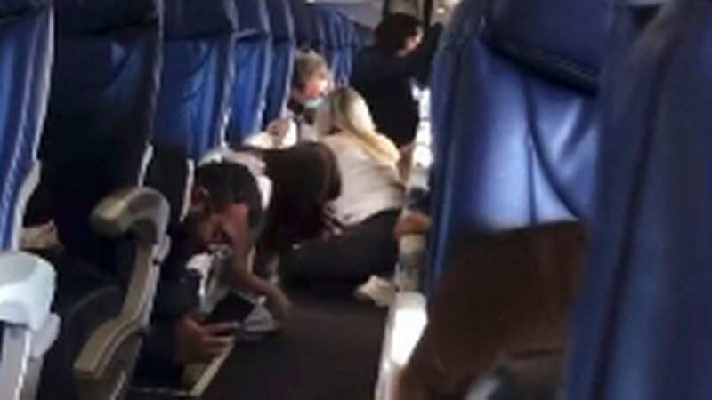 Panicked passengers scramble for cover as plane hit by gunfire during takeoff