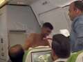 Topless thug brawls with another passenger on packed plane in row over seats dqxikeidqkikdinv