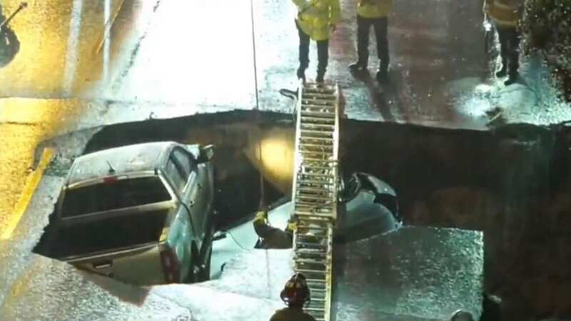 Sinkhole swallows two cars whole as firefighter heroes rescue mum and daughter