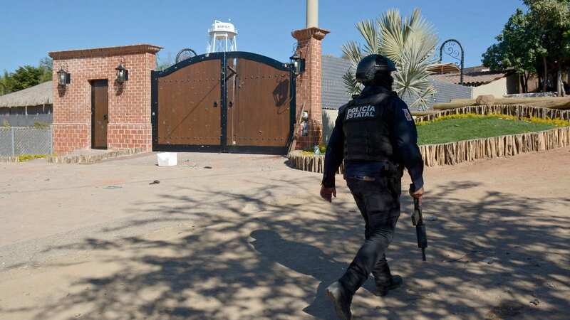 A police officer walks past the compound where Guzman was hiding (Image: AFP via Getty Images)