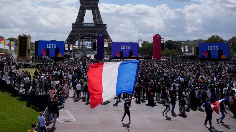 IOC president Thomas Bach gives the Olympic flag to Paris mayor Anne Hidalgo. Ukraine and their allies are threatening to boycott next year