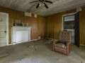 Inside creepy abandoned home of doctor with ghostly figures and graves in yard
