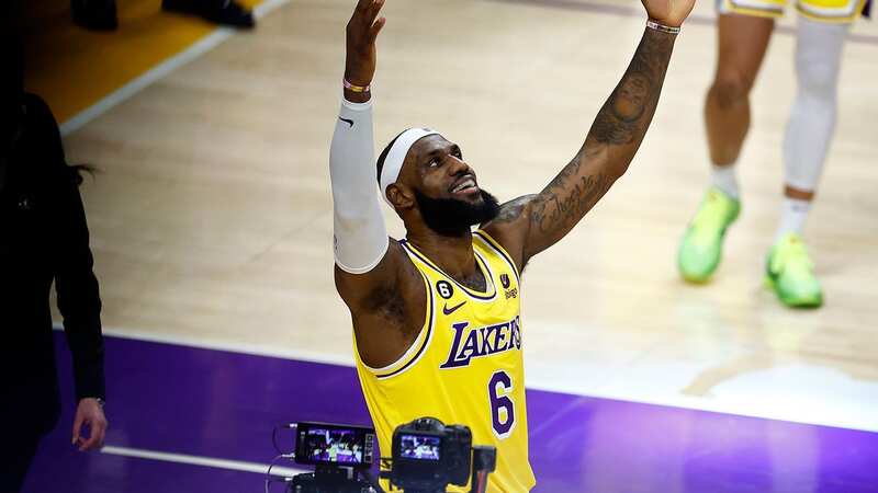 Kareem Abdul-Jabbar stands on court with LeBron James after the all-time record is broken