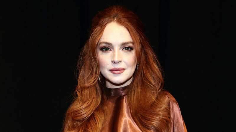 Lindsay Lohan glows in ultra rare public appearance with family at Fashion Week