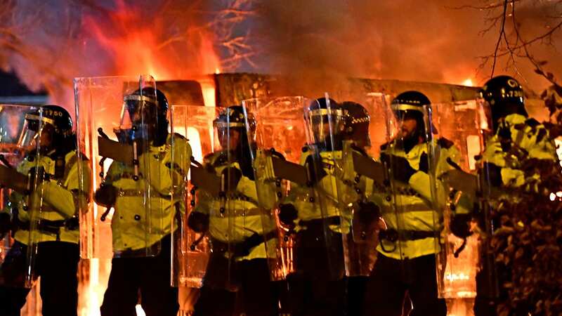Riot as police van on fire, missiles thrown and protesters surround hotel