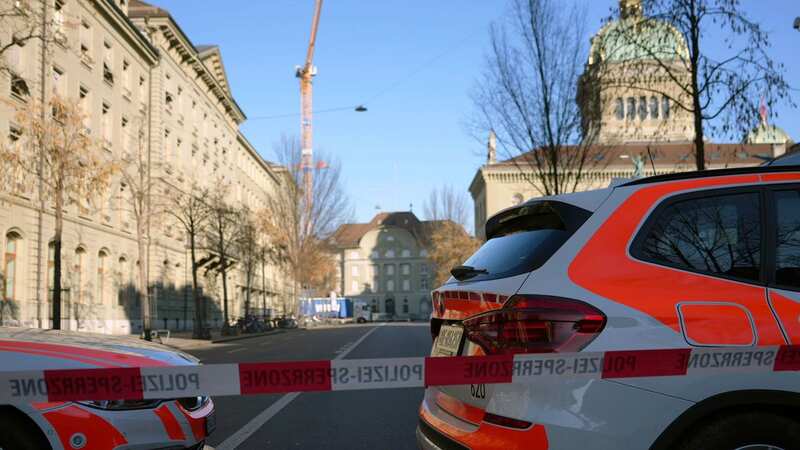 Police vehicles are parked in front of the Swiss Parliament, the Bundeshaus, during a large-scale operation (Image: AP)