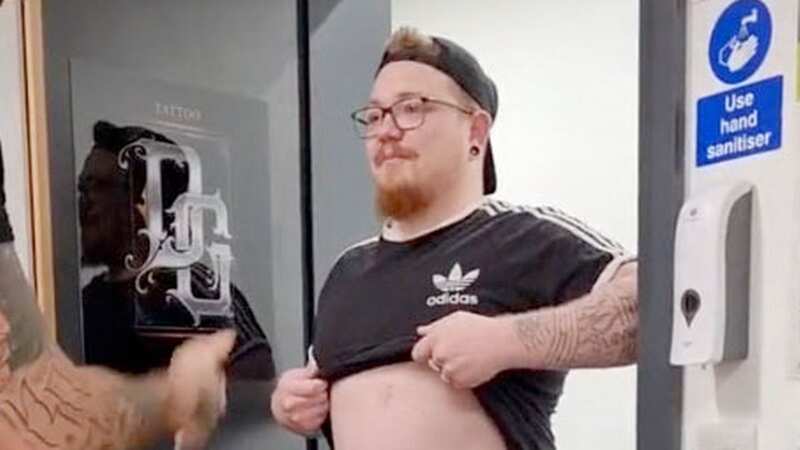 A man wanted a six-pack so badly he got one tattooed on his stomach (Image: Caters)