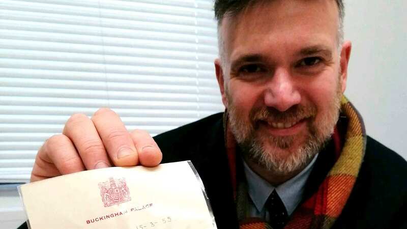 Head auctioneer Charles Hanson with a letter addressed from young King Charles found in a couple