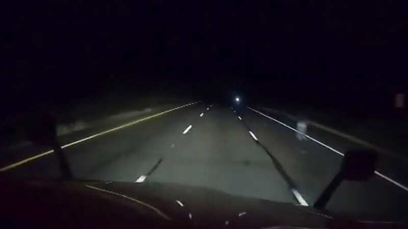 Truck driver captures mysterious ghost figure standing in dark highway roadside