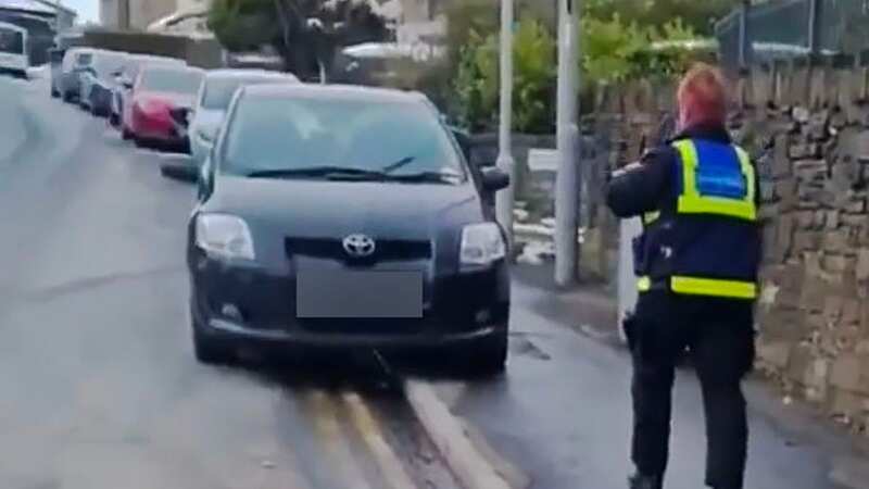 Moment parking officers slap ticket on car left abandoned in blizzard