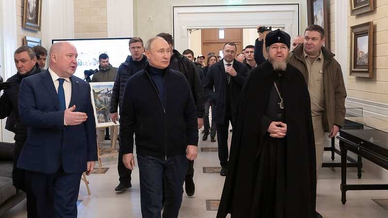 Putin limps stiffly with head bowed down in first sighting since arrest warrant