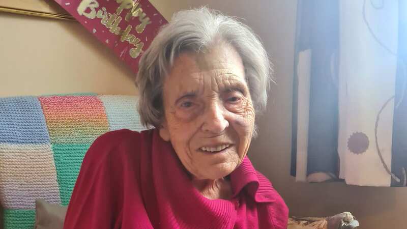 Olive loves reading, knitting, and sewing - and used to play football until she was 80 (Image: Jam Press/Birchland Care Home)