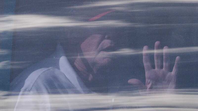 Trump waves from the back of a limo as he leaves the International Golf Club in West Palm Beach, Florida (Image: AFP via Getty Images)