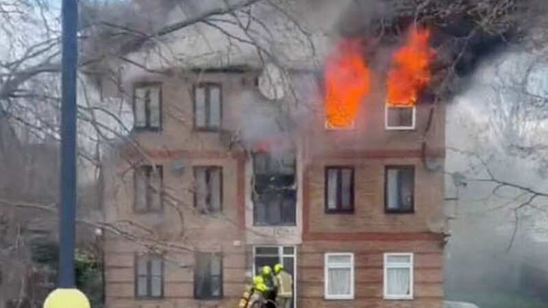 A man has been arrested on suspicion of murder after a woman died in a fire at a block of flats in East London (Image: UkNewsinPictures)