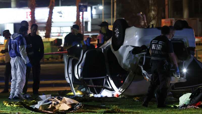 Israeli police and emergency service stand around a car involved in an attack in Tel Aviv (Image: AP)