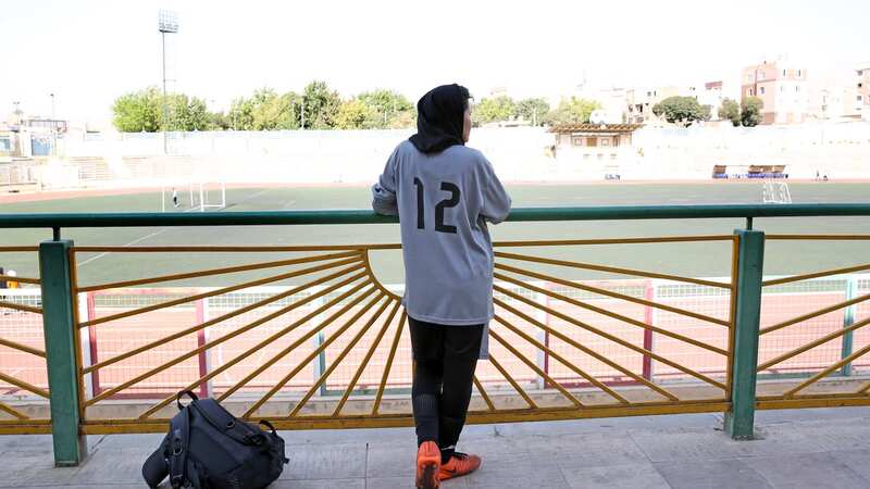 Afghanistan Flag beside the soccer balls on the field in Tehran in 2021