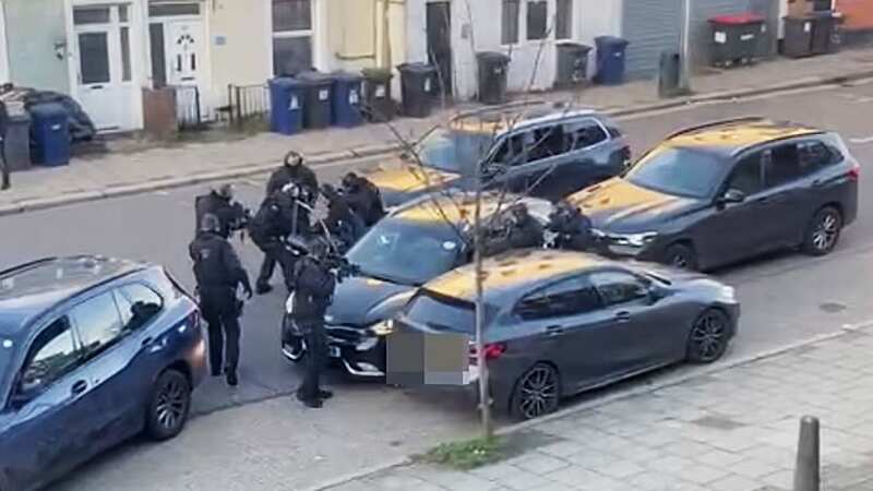 Armed police swarm around a car following a shooting by St Aloysius Church, London