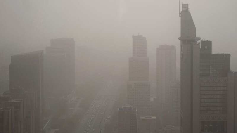 Beijing has been shrouded in dust for days and the poor visibility is still ongoing (Image: AP)