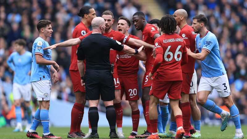 Liverpool players surrounded Simon Hooper to appeal for a red card (Image: Getty Images)