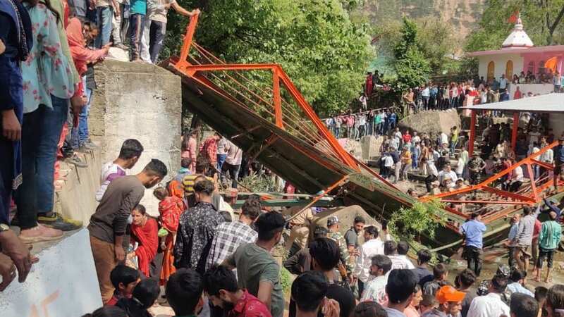 People crowd near a steel footbridge which collapsed during the Baisakhi fair in Udhampur, near Jammu, India (Image: Uncredited/AP/REX/Shutterstock)