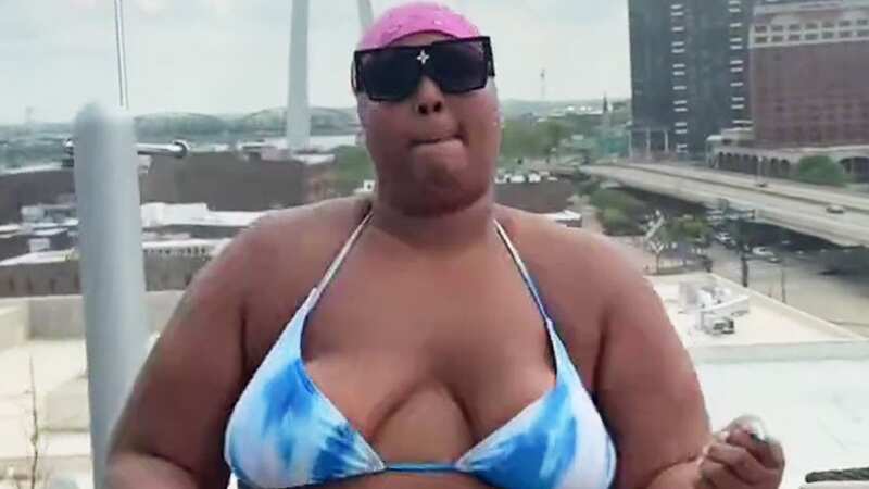 Lizzo shows off flexibility in tiny string bikini while dancing on hotel balcony