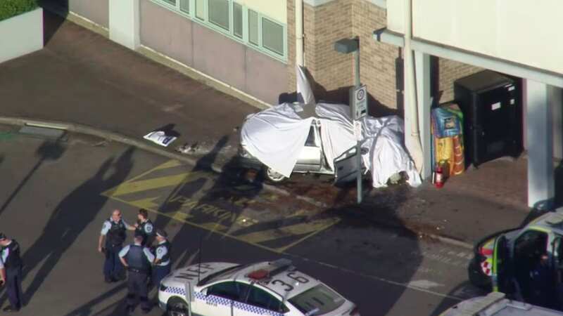 Two people have died after a car crashed into the side of a hospital in Sydney