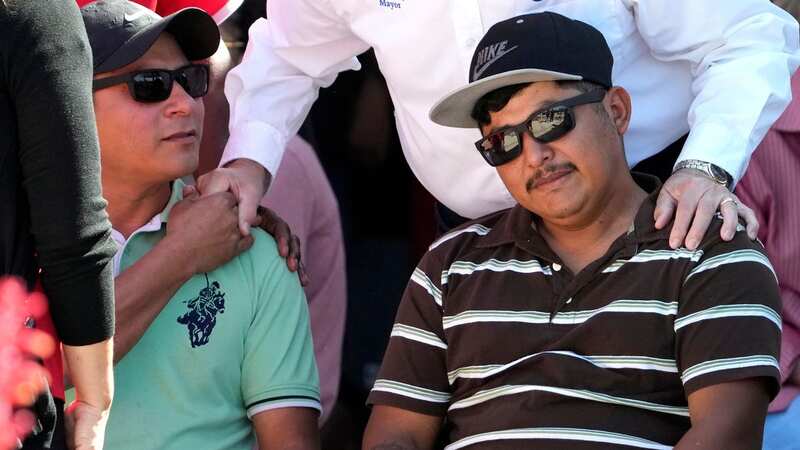 Wilson Garcia, right, is consoled during a vigil for his son, Daniel Enrique Laso, 9, Sunday, April 30, 2023, in Cleveland, Texas. Garcia, who survived a mass shooting, lost his son and wife in the shooting Friday night. (Image: AP)