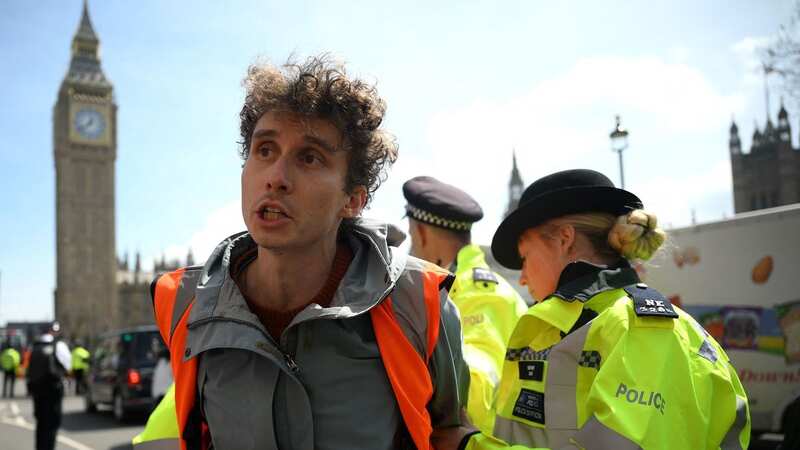 Cameron Ford is hauled away by police (Image: AFP via Getty Images)