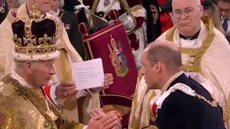 Prince William read his lines off a cue card while kneeling to King Charles (Image: Sky News)