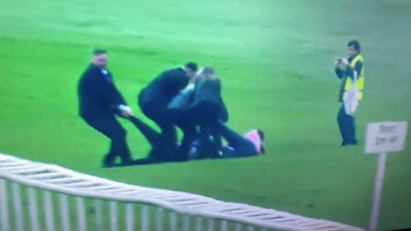 Security staff remove protesters from the track at Doncaster
