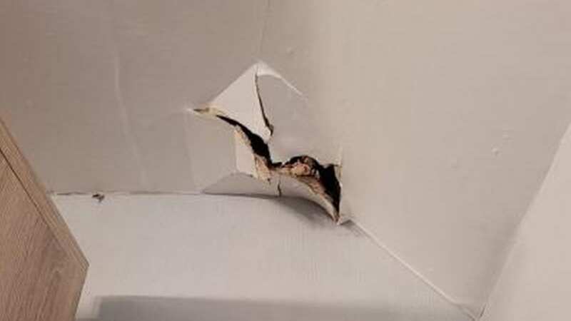 A hole discovered in the home appeared as though a foot had gone though their ceiling (Image: BPM Media)