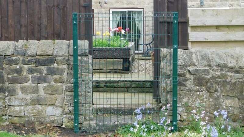 The council fenced over the garden entrance to the homes and says there are no access rights to its land (Image: Derby Telegraph)