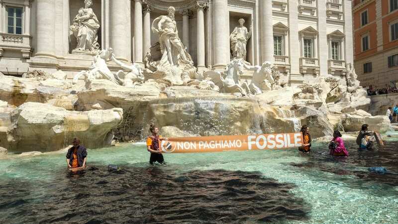 Climate activists dye famous Rome fountain black after floods kill at least 15