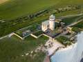 Huge part of iconic UK cliff collapses into sea as lighthouse teeters on edge