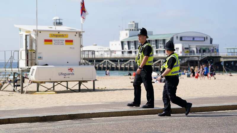 Police officers walk along Bournemouth beach (Image: PA)