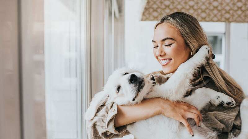 It can be tempting to hug your dog - but there are better ways to show affection (Stock Photo) (Image: Getty Images)