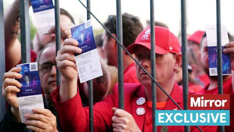 Liverpool fans stuck outside the ground show their match tickets (Image: PA)