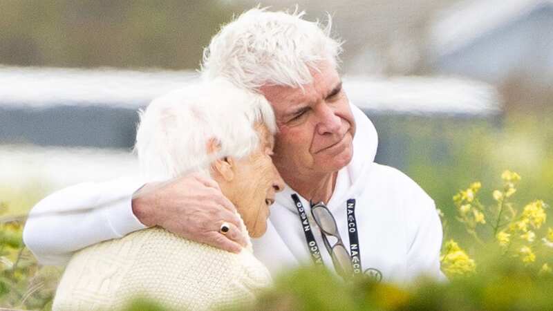 Phillip pictured comforting his mum Pat