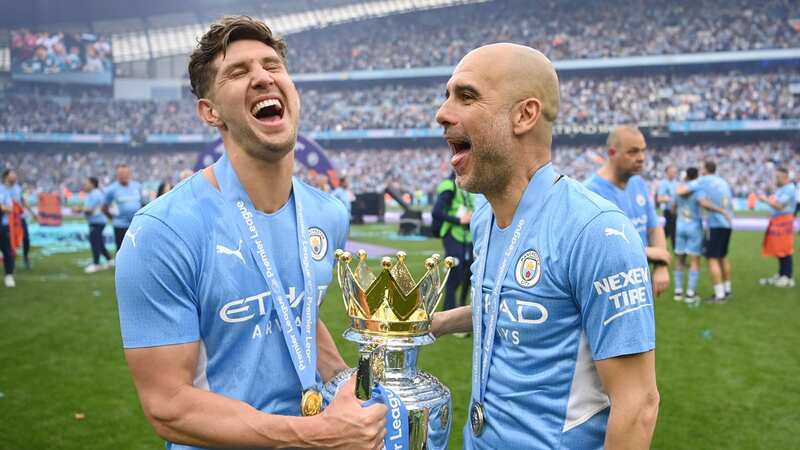 John Stones and Pep Guardiola celebrate Manchester City