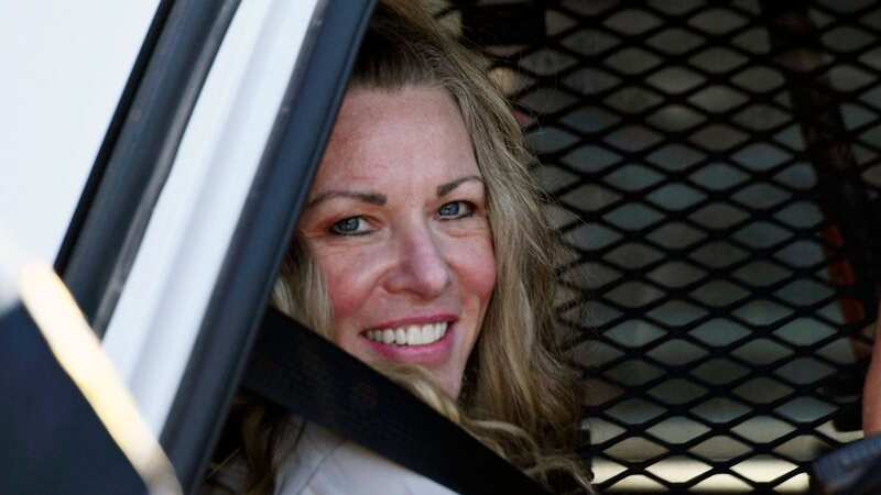 Lori Vallow smiles in the back of a squad car (Image: Tony Blakeslee/AP/REX/Shutterstock)