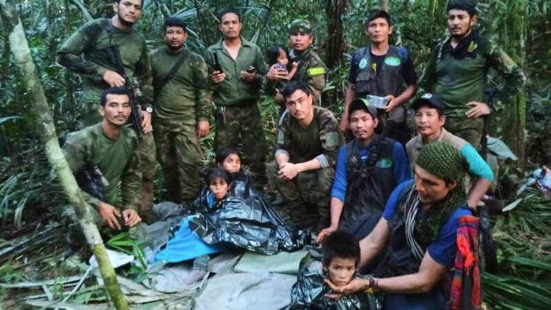 Soldiers and Indigenous men pose for a photo with the four Indigenous children (Image: AP)