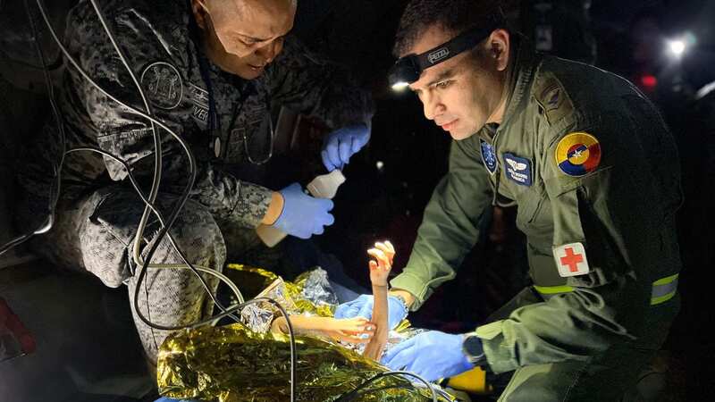 Tot Cristin Neriman Ranoque Mucutuy is checked and given water (Image: Colombian Air Force/AFP via Gett)