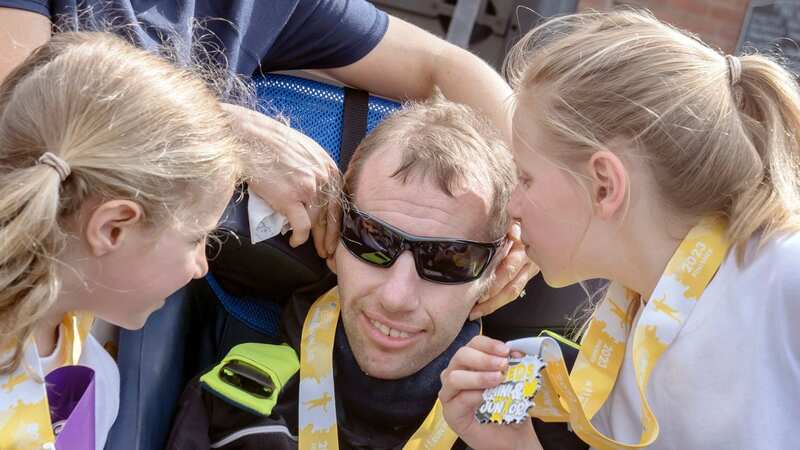 Rob Burrow was pushed round the course by his children (Image: PA)