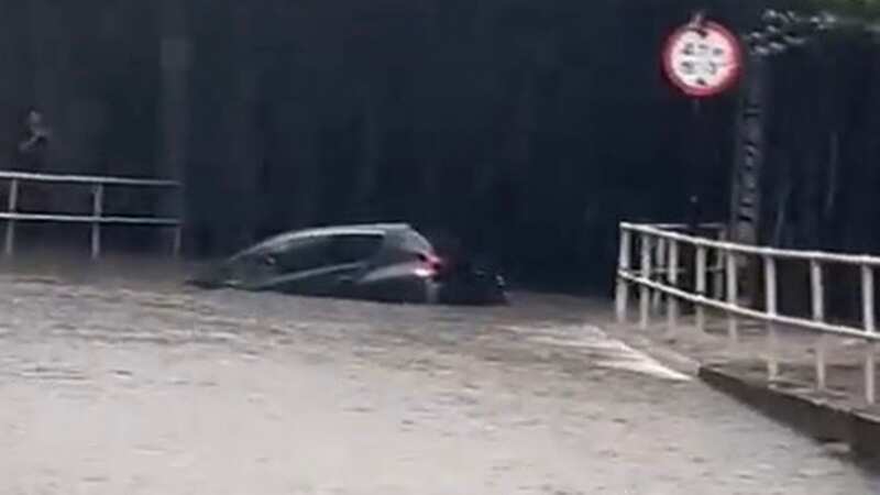 Dramatic moment woman rescued from trapped car as flood alerts issued across UK