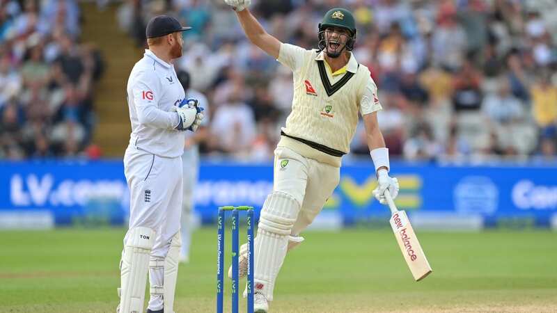 Pat Cummins celebrates after hitting the winning runs