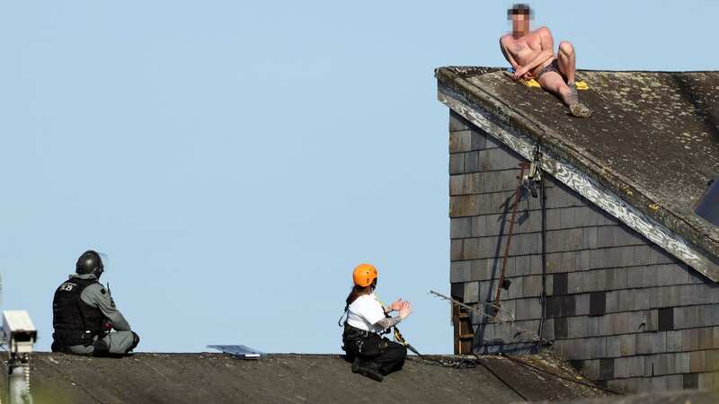 Prisoner in underpants climbs on jail roof sparking stand-off with riot cops