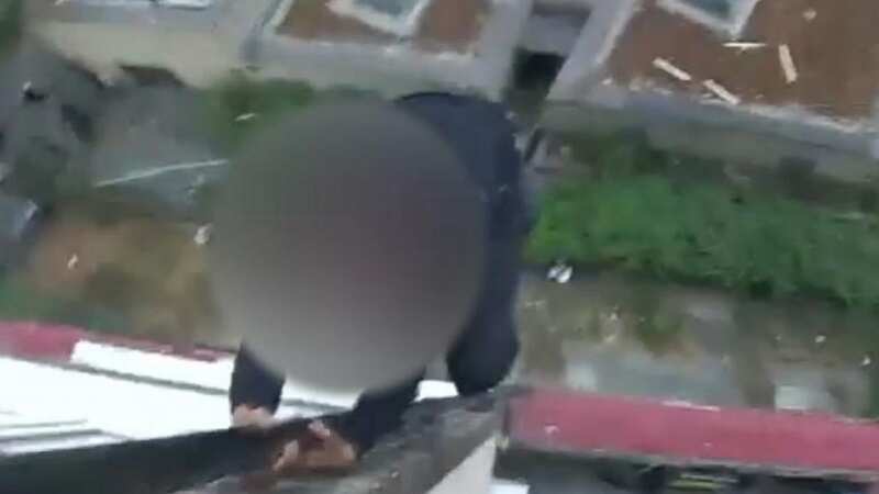 Moment police officer pepper sprays robber dangling from tower block