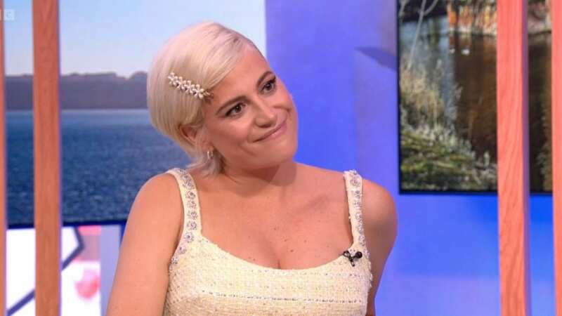 Pixie Lott shows off blossoming baby bump in mini dress amid 