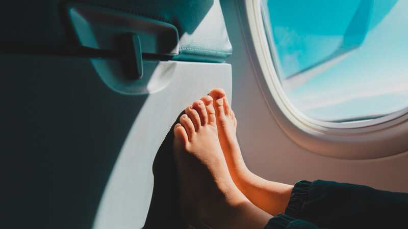 The woman rested her bare feet on his armrest (stock photo) (Image: Getty Images/iStockphoto)