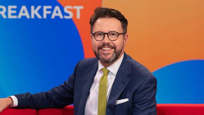 BBC Breakfast presenter Jon Kay missing from red sofa as he explains absence (Image: BBC/James Stack)